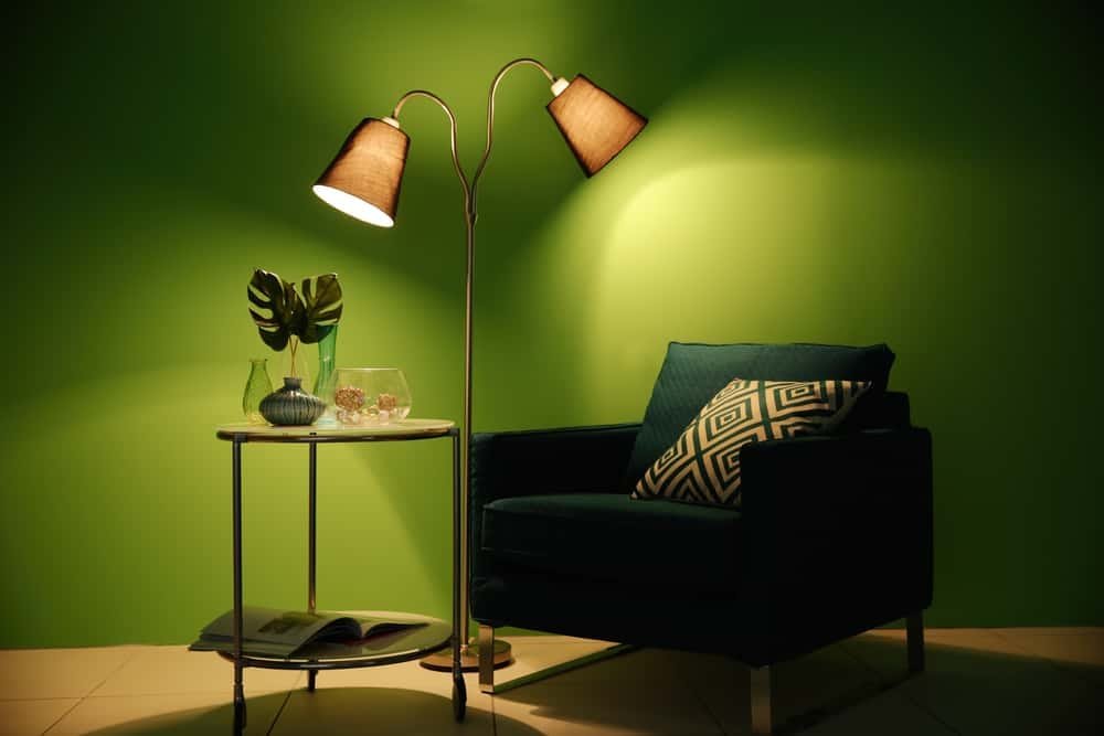A warm living room illuminated in layers by pendant, table and accent lights