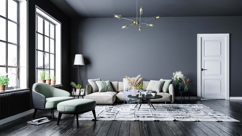 A bright living room with a sofa and armchairs balanced around a central coffee table
